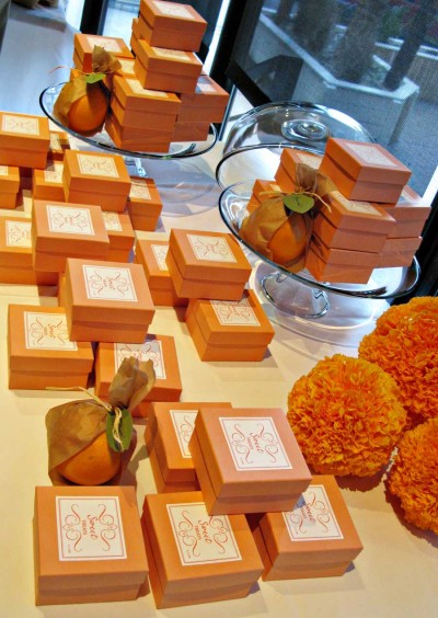 favor-box-table-using-cake-trays-and-tissue-paper-pomanders-as-props