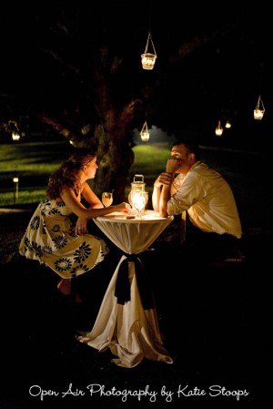 outdoor-wedding-cocktail-table-with-tealights-hanging-from-trees