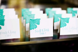 tropical-teal-theme-escort-cards-whimsical-calligraphy