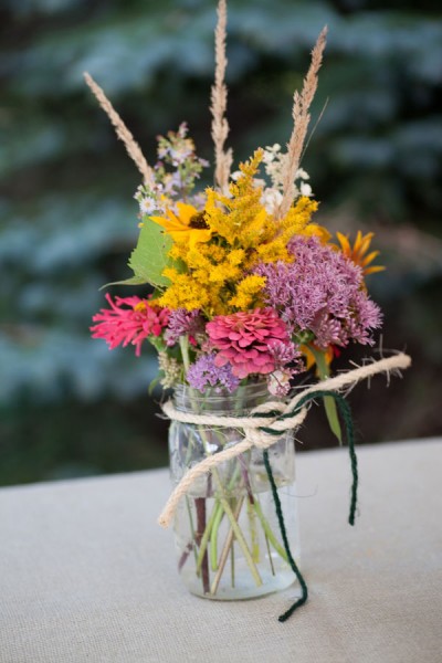 wildflower-centerpieces-in-mason-jars-yellow-purple-pink