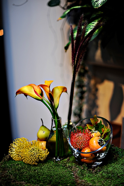 yellow-and-orange-centerpieces-on-moss