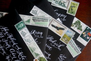 white-ink-calligraphy-black-envelopes-vintage-stamps