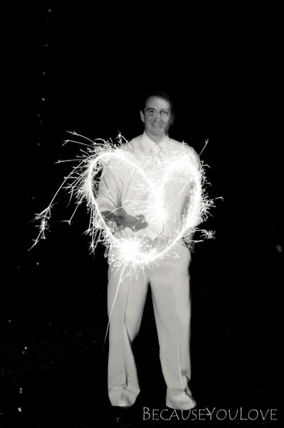 groom with sparklers