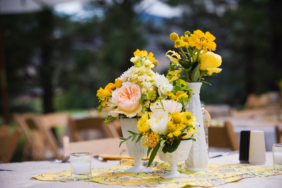 Rustic Table Decor with Wine Bottles, Roses, and Hydrangeas at The  Enchanted Barn