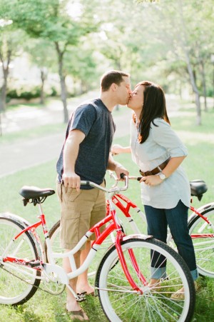 Couple Kissing on Red Bikes