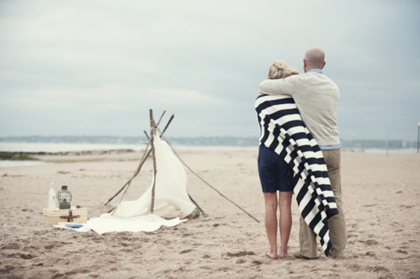 Couple Looking at Tent on the Beach