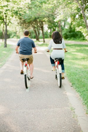 Couple Riding Red Bikes in Park
