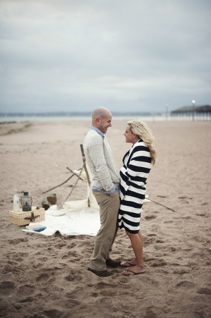 Engagement Photo Wearing Striped Blanket
