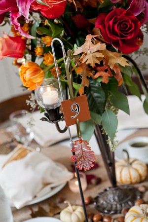 Fall Reception Centerpieces With Leaves and Red and Orange Flowers