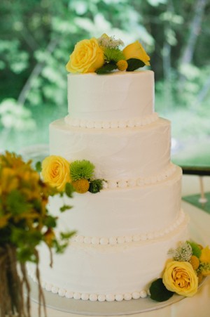 Four Tier Round Wedding Cake With Yellow Flowers