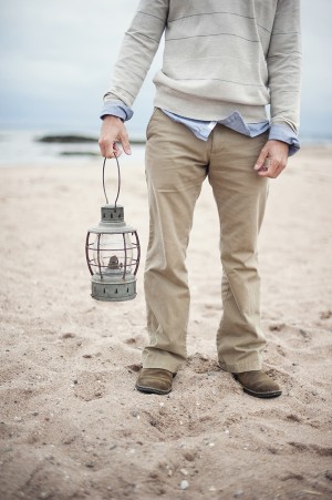 Male Holding Lantern on the Beach