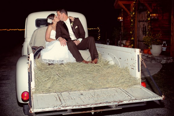 Bride and Groom in Old Truck Bed With Hay