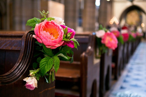 Lush Pink Flower Markers on Church Pews