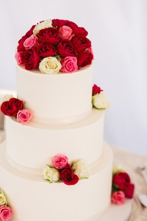 Round Wedding Cake With Pink Red and Ivory Roses