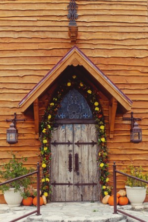 Rustic Chapel Door With Fall Garland and Pumpkins