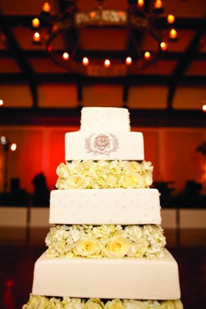 Square Tiered Wedding Cake With Flowers and Cipher
