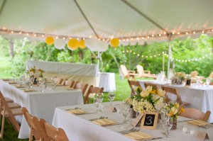 White Reception Tent With Lights and Yellow and Green Decor