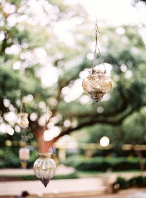 Amber Colored Votive Holders Hanging in Trees