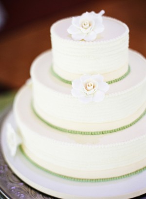 Three Tier Round Wedding Cake With Flowers and Green Icing Details