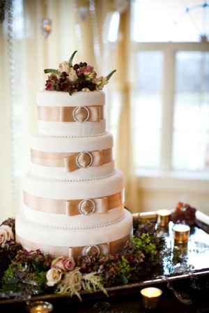 Wedding Cake With Silk Ribbon and Jeweled Brooch on Layers
