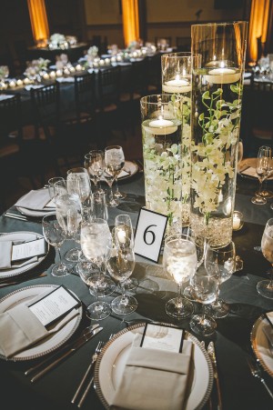 White Floral Branches Floating in Tall Glass Vases 1