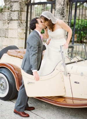 Bride and Groom Kissing in Antique Car