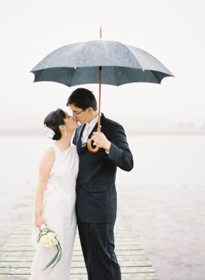 Couple Kissing Beneath Umbrella