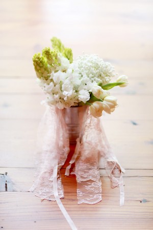 Pale Flowers in Silver Vase With Ribbons and Lace