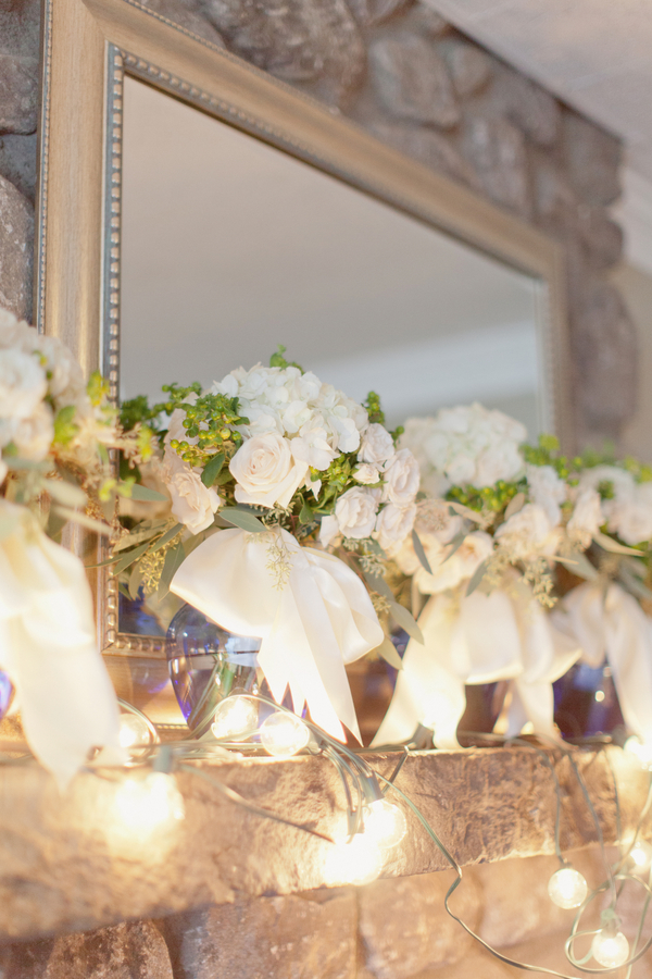 White and Green Bouquets on Stone Mantel