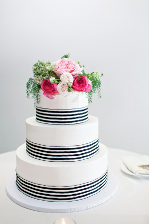Round Wedding Cake With Pink Flowers and Navy and White Striped Ribbon