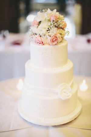 Simple White Wedding Cake With Flower Bouquet Topper