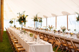 Tent Reception With Long Tables and Wooden Chairs