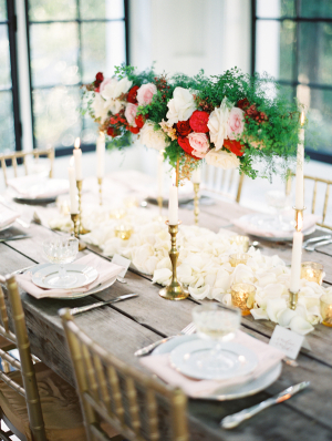 Wood Table With Rose and Fern Garland and Gold Candlesticks