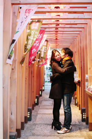 Couple Embracing Beside Japanese Flags