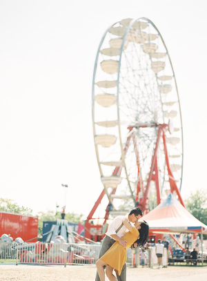 Couple Kissing by Ferris Wheel