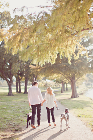 Engaged Couple Walking With Dogs