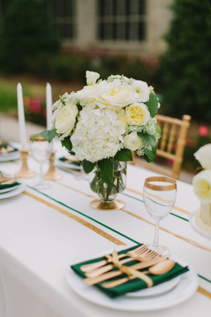 Green and Gold Table Linens With White Flowers
