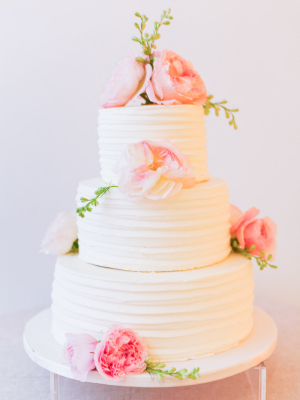 Wedding Cake With Combed Icing and Fresh Flowers