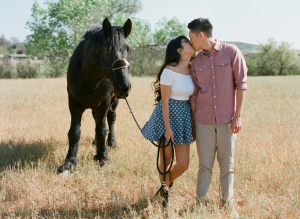 Couple in Field With Horse