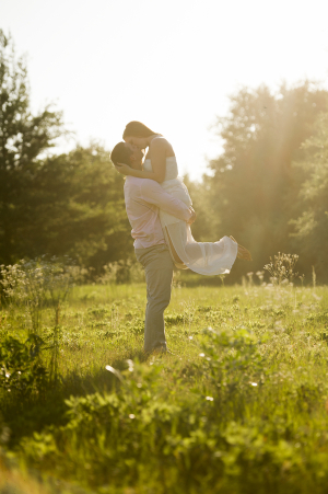 Engaged Couple Kissing in Field