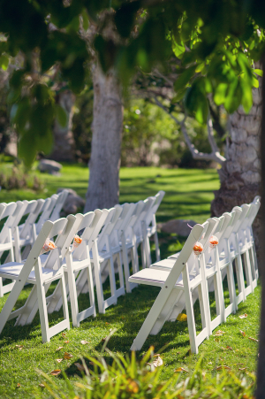 White Folding Chairs at Outdoor Wedding Ceremony