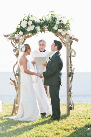 Curly Wood Wedding Arbor With White Floral Garland