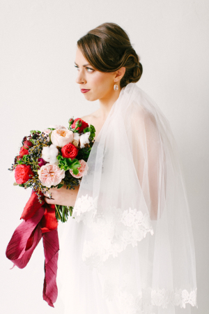 Elegant Bride with Red Bouquet