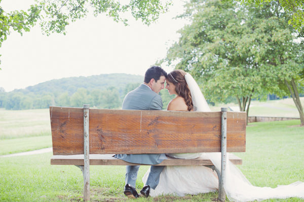 Bride and Groom Sitting on Bench