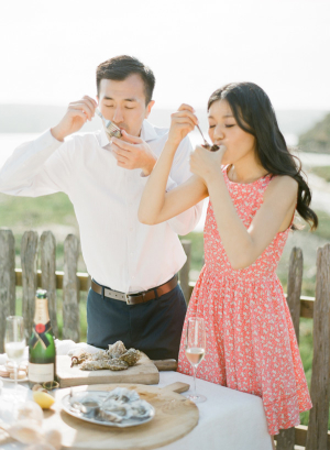 Couple Eating Oysters on Beach