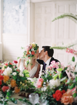 Couple Kissing at Floral Filled Table
