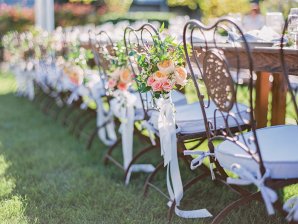 Flowers on Wrought Iron Chairs at Wedding