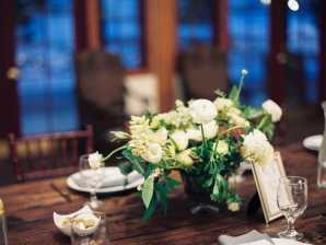White and Green Centerpiece on Wood Table