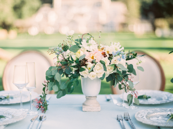 Green and White Centerpiece on Blue Table