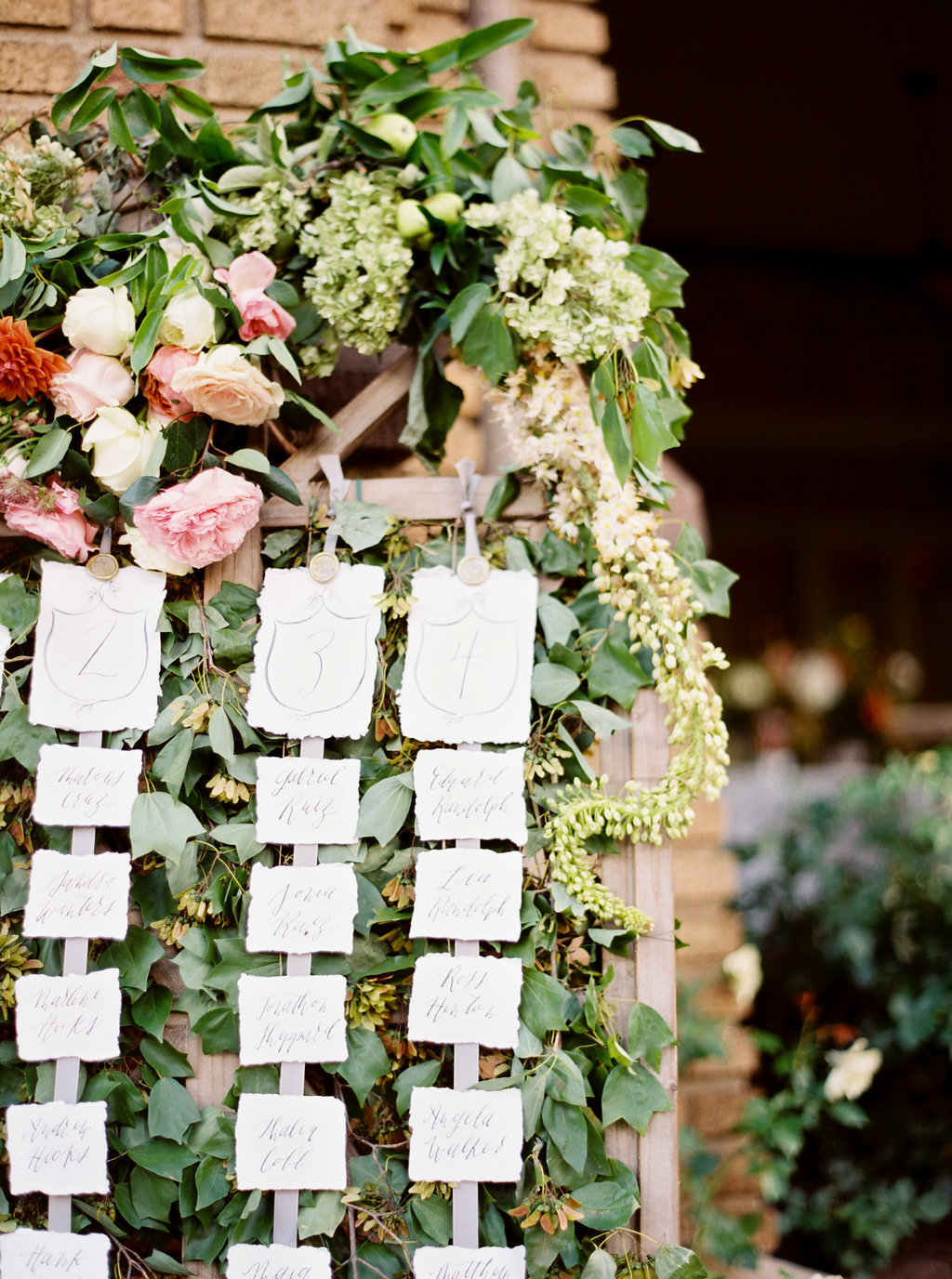 Escort Cards on Greenery Bed